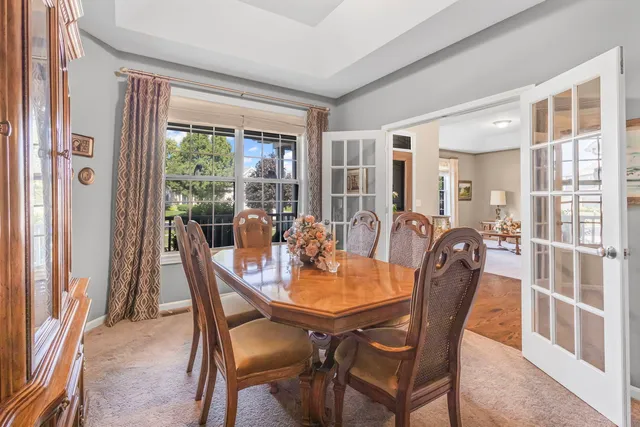 a view of a dining room and livingroom with furniture wooden floor and a rug
