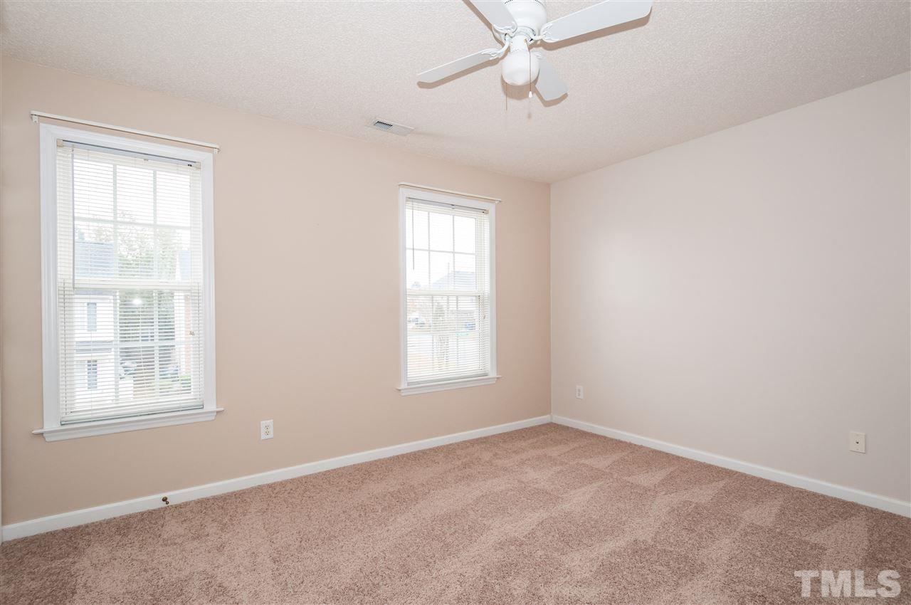 2301 Bay Harbor Drive Raleigh, NC 27604 - Photo 13 of 25 an empty room with a window and ceiling fan