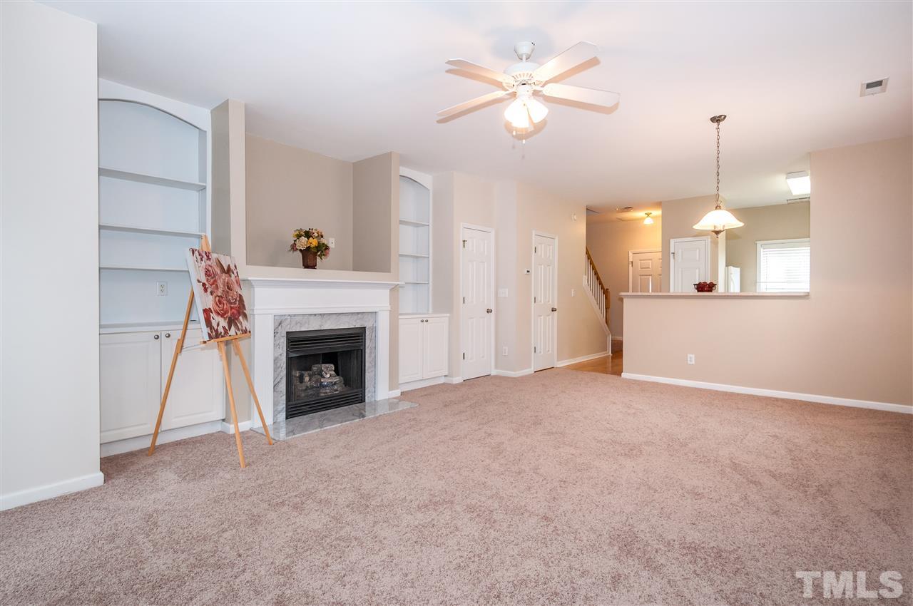 2301 Bay Harbor Drive Raleigh, NC 27604 - Photo 3 of 25 a view of a livingroom with a fireplace a ceiling fan and fireplace