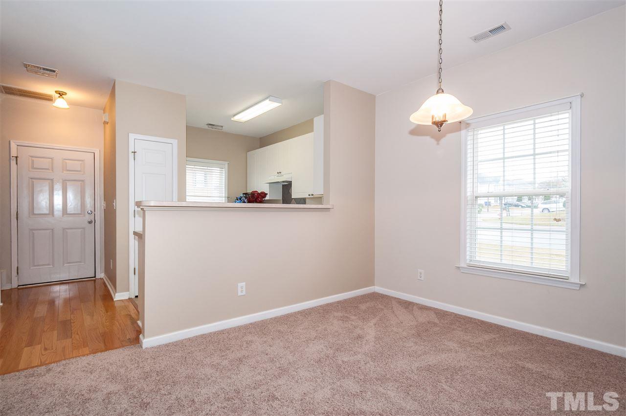 2301 Bay Harbor Drive Raleigh, NC 27604 - Photo 5 of 25 a view of a kitchen with wooden cabinet and chandelier