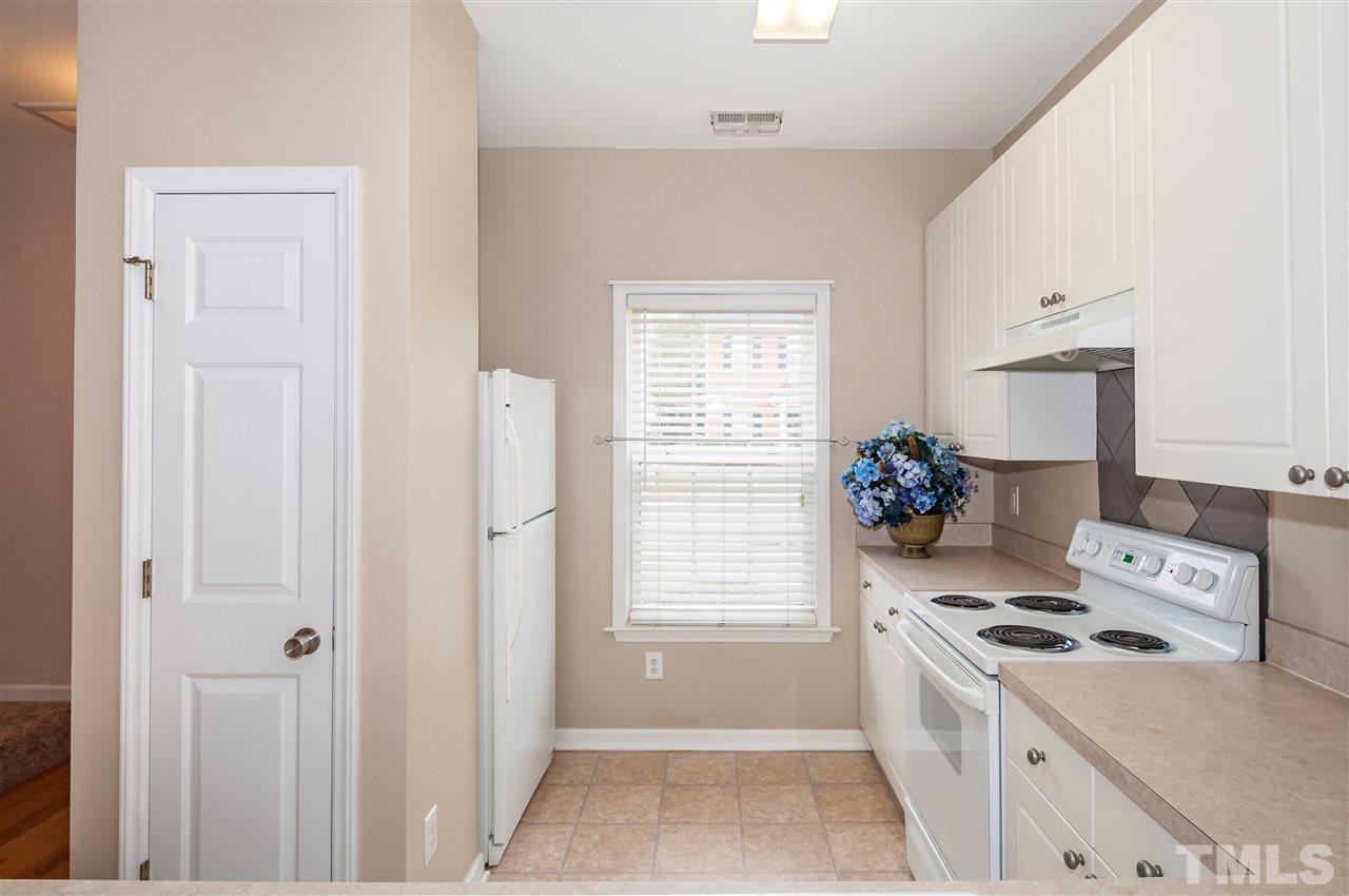 2301 Bay Harbor Drive Raleigh, NC 27604 - Photo 8 of 25 a kitchen that has a stove and a refrigerator
