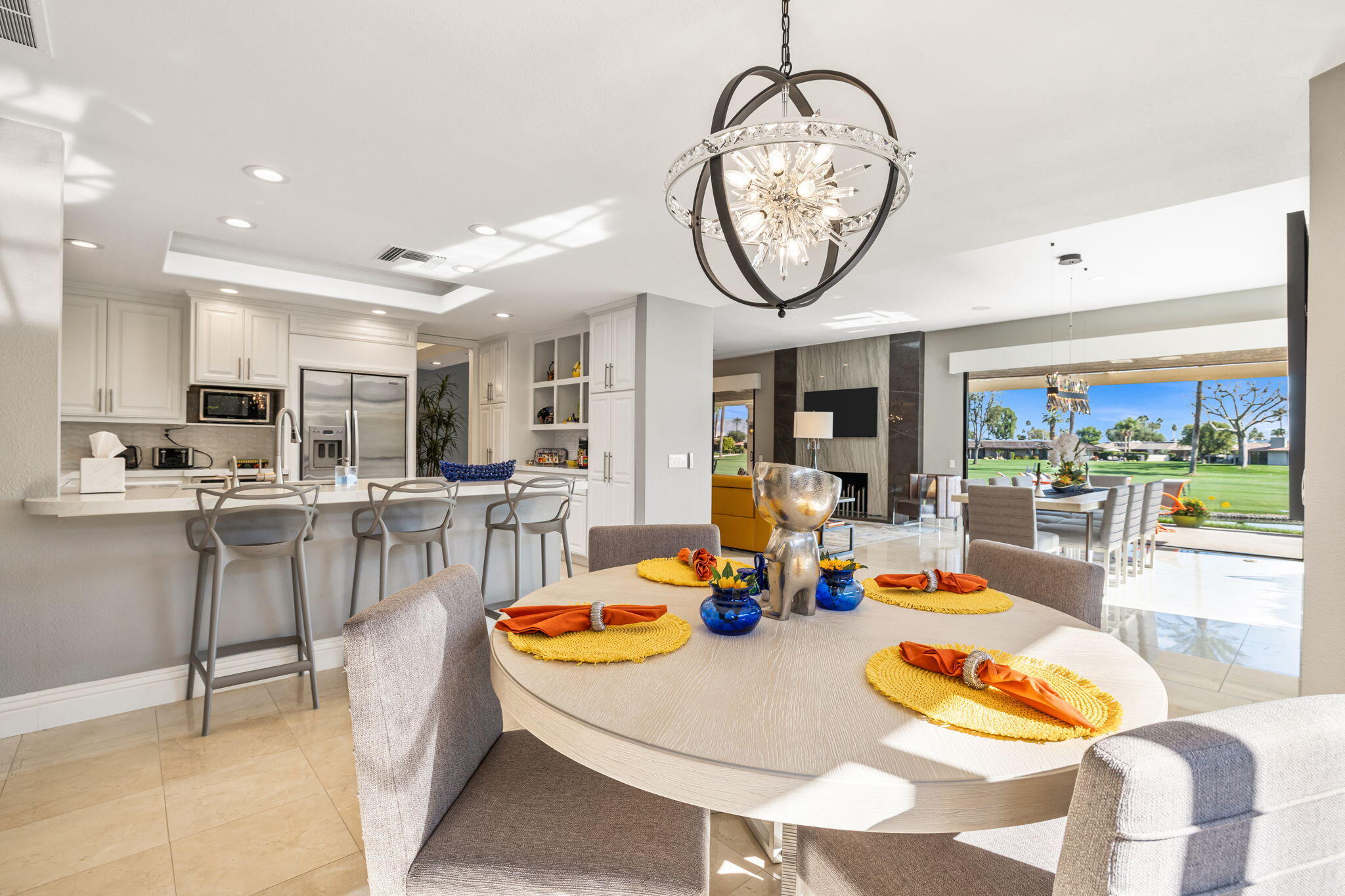 6 Barnard Court Rancho Mirage, CA 92270 - Photo 14 of 58 a dining room with wooden floor a glass table and chairs