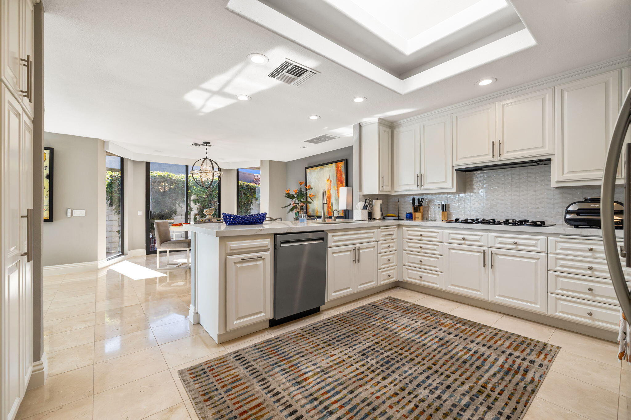 6 Barnard Court Rancho Mirage, CA 92270 - Photo 22 of 58 a kitchen with a refrigerator cabinets and a counter top space