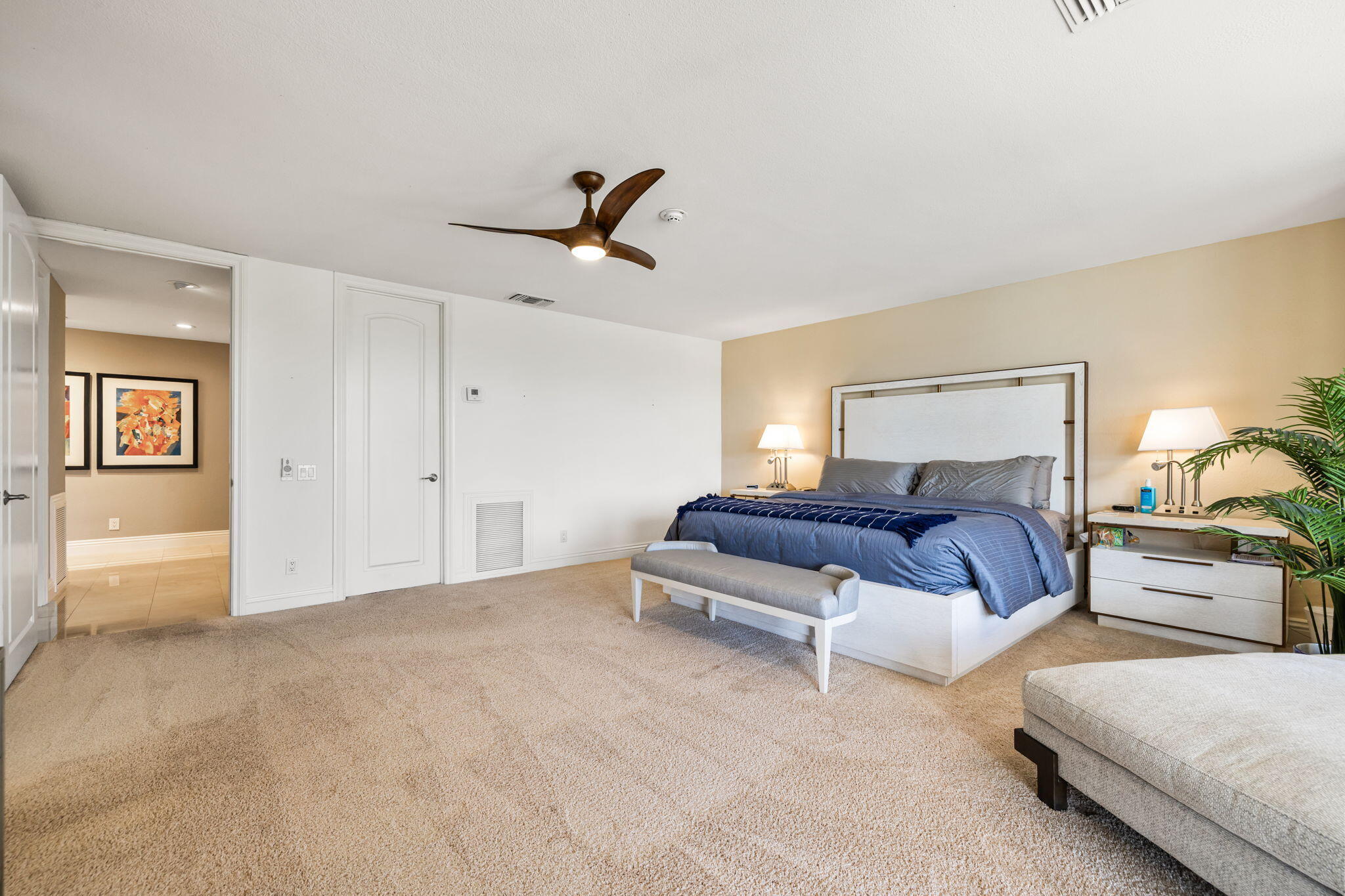 6 Barnard Court Rancho Mirage, CA 92270 - Photo 33 of 58 a spacious bedroom with a bed and ceiling fan