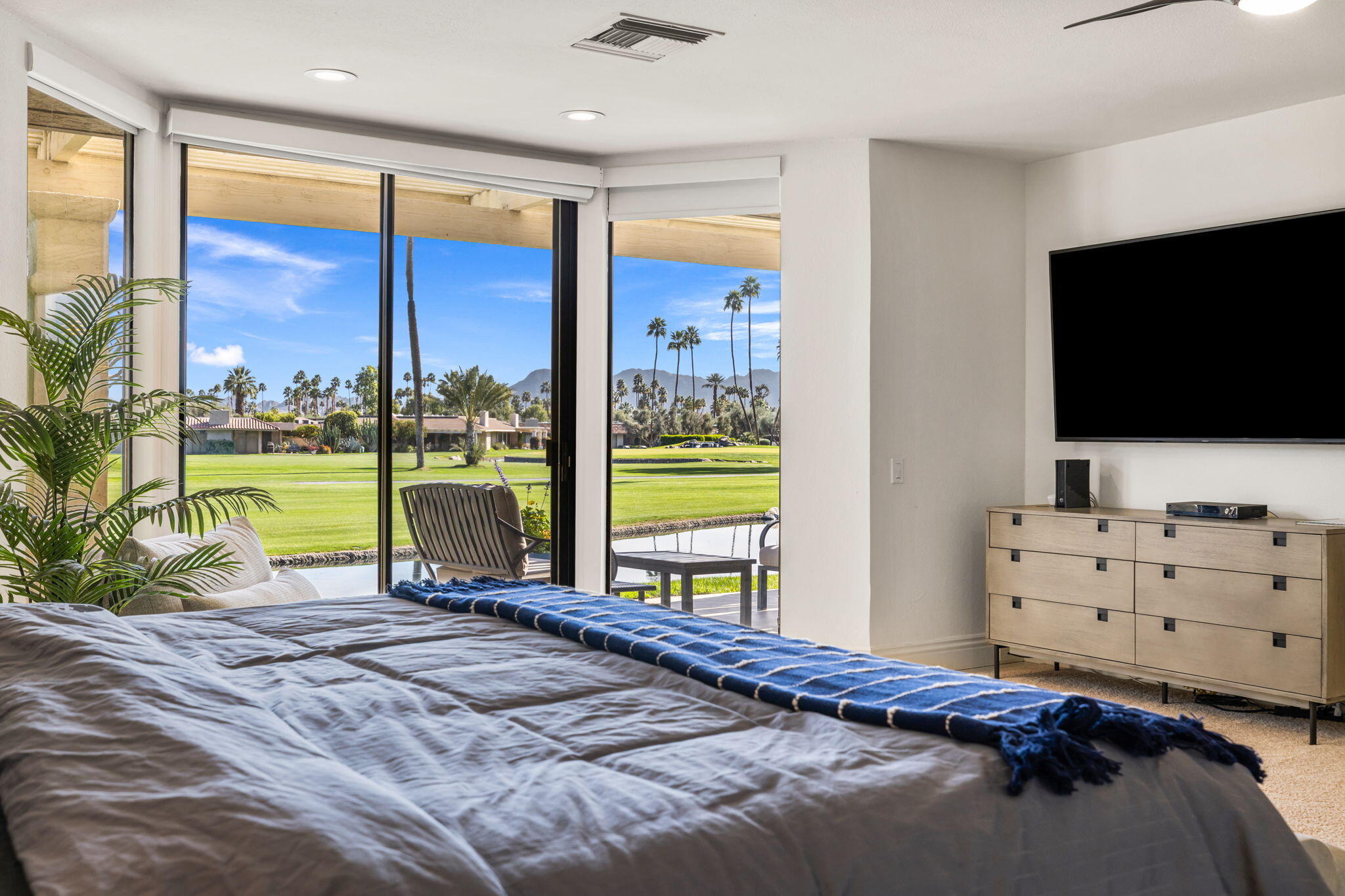 6 Barnard Court Rancho Mirage, CA 92270 - Photo 35 of 58 a bedroom with a large window and a flat screen tv