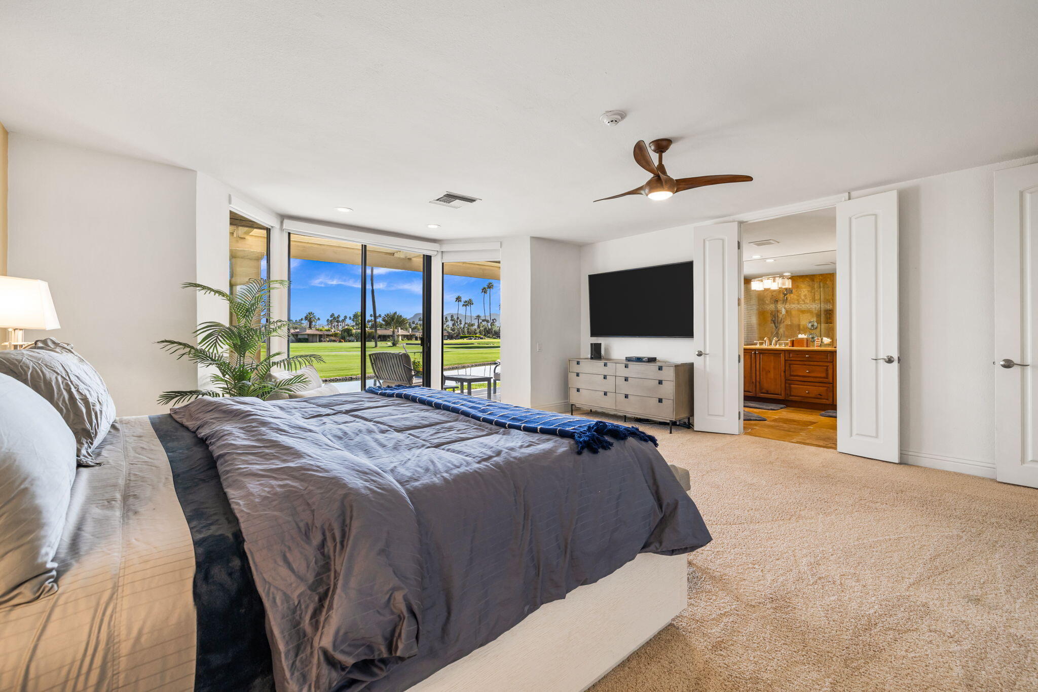 6 Barnard Court Rancho Mirage, CA 92270 - Photo 36 of 58 a spacious bedroom with a large bed and a flat tv screen