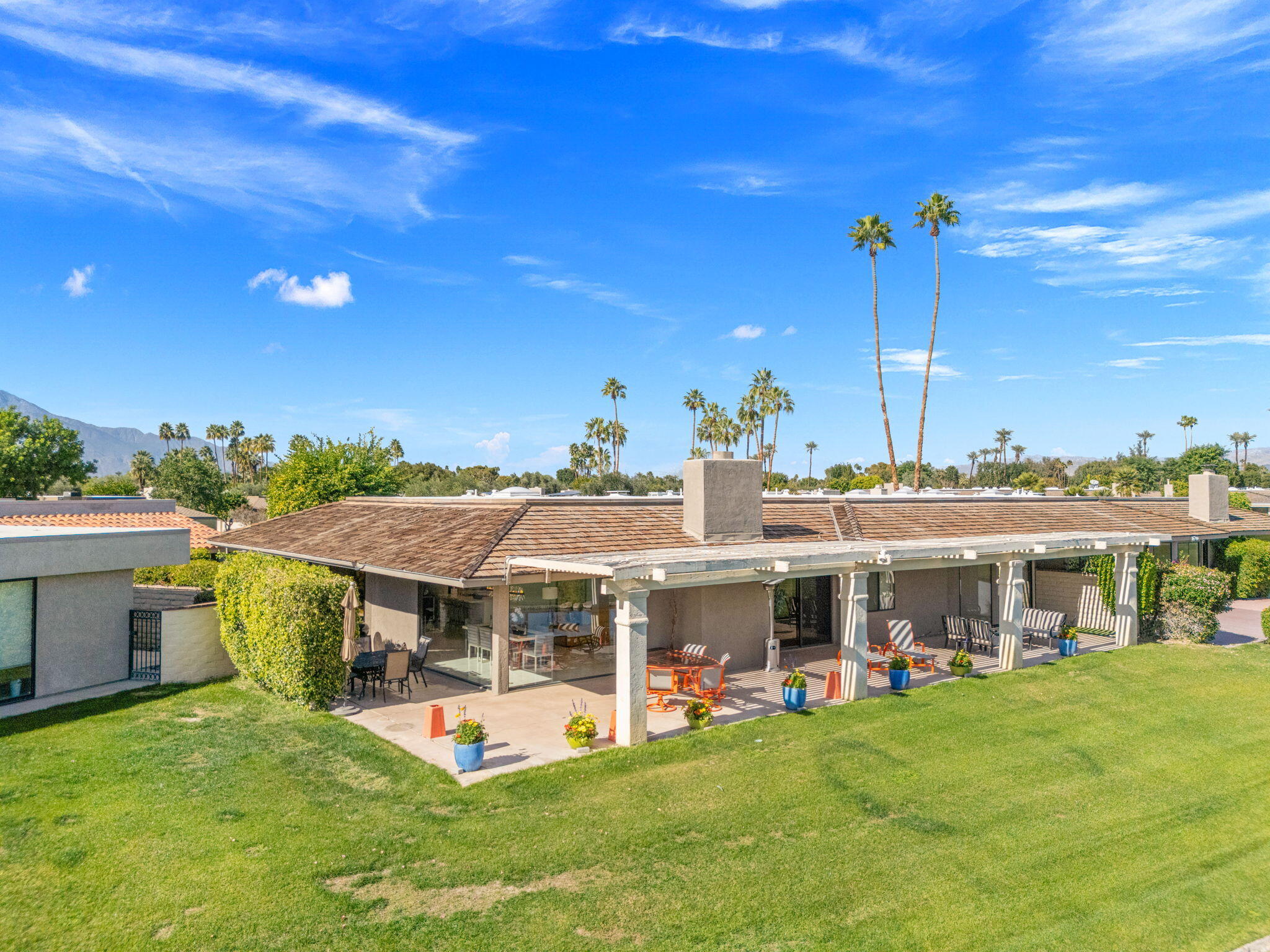 6 Barnard Court Rancho Mirage, CA 92270 - Photo 45 of 58 a view of a house with a backyard porch and sitting area