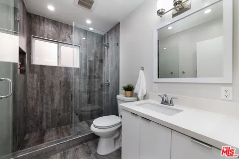 a bathroom with a shower and a sink