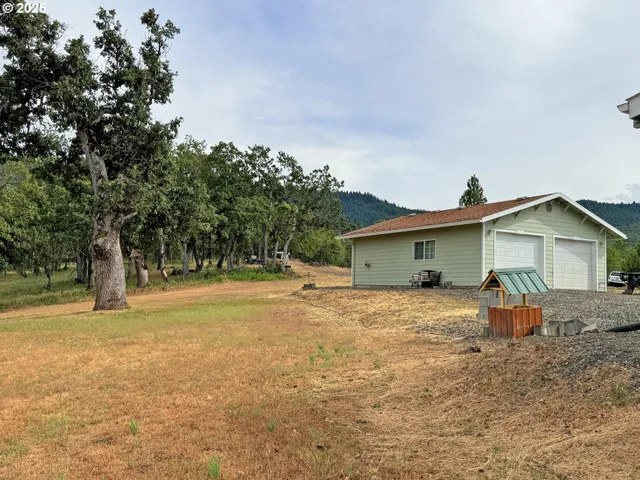 a house that has a tree in front of it