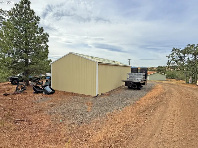 a view of a house with truck parked on the road