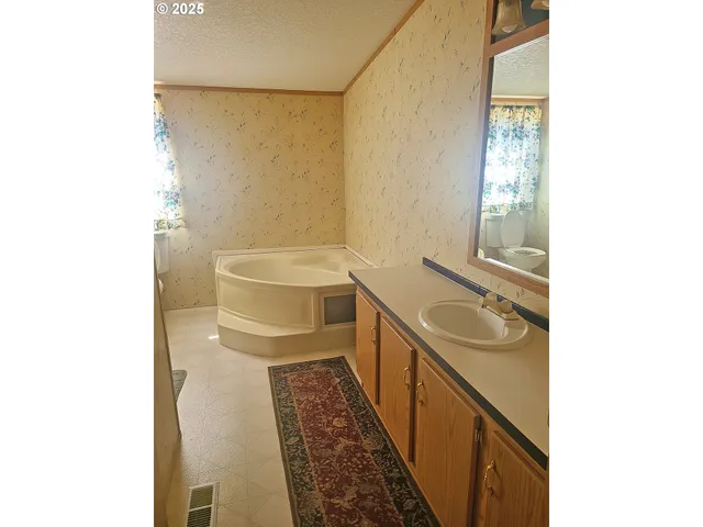 a bathroom with a sink a toilet and a mirror
