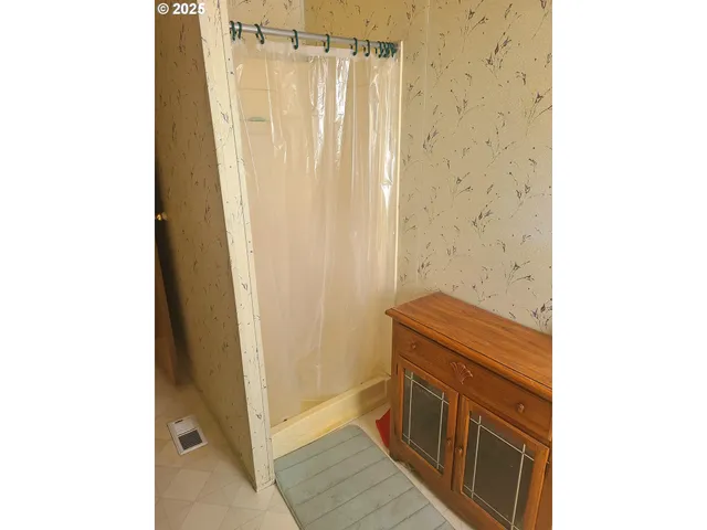 a bathroom with a sink a vanity and a shower