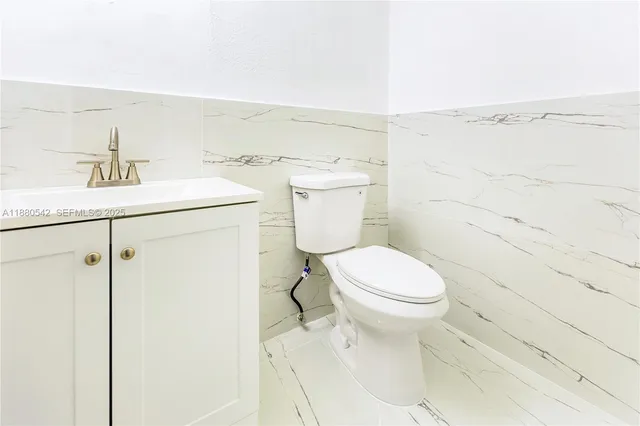 a bathroom with a sink a toilet and vanity