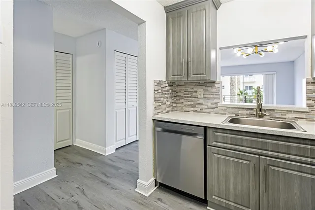 a kitchen with a sink and cabinets