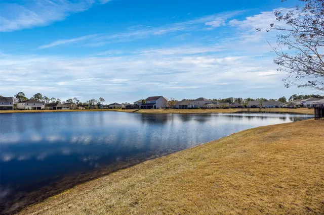 a view of a lake with houses in the background