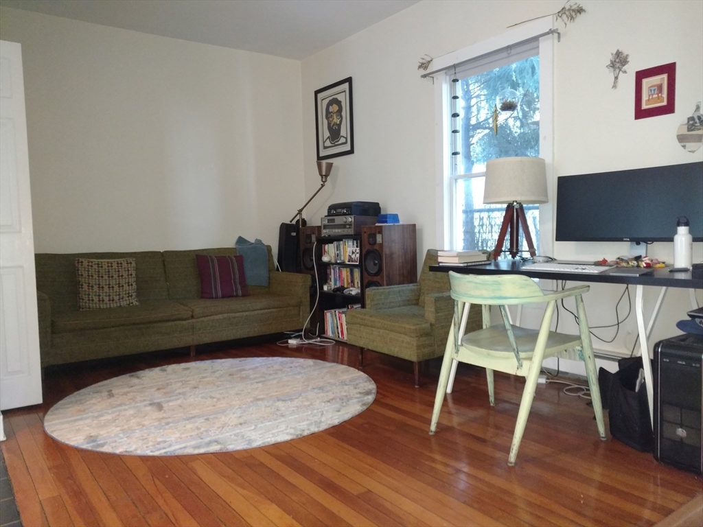 26 Hingham Street, Unit 2 Cambridge, MA 02138 - Photo 3 of 11 a living room with a couch and a wooden floor