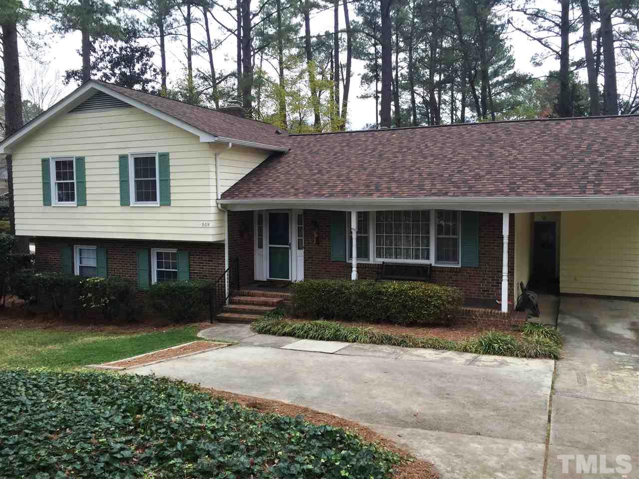 505 East Millbrook Road Raleigh, NC 27609 - Photo 1 of 25 a front view of a house with a yard and garage
