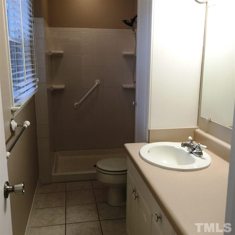 505 East Millbrook Road Raleigh, NC 27609 - Photo 14 of 25 a bathroom with a sink a toilet and shower