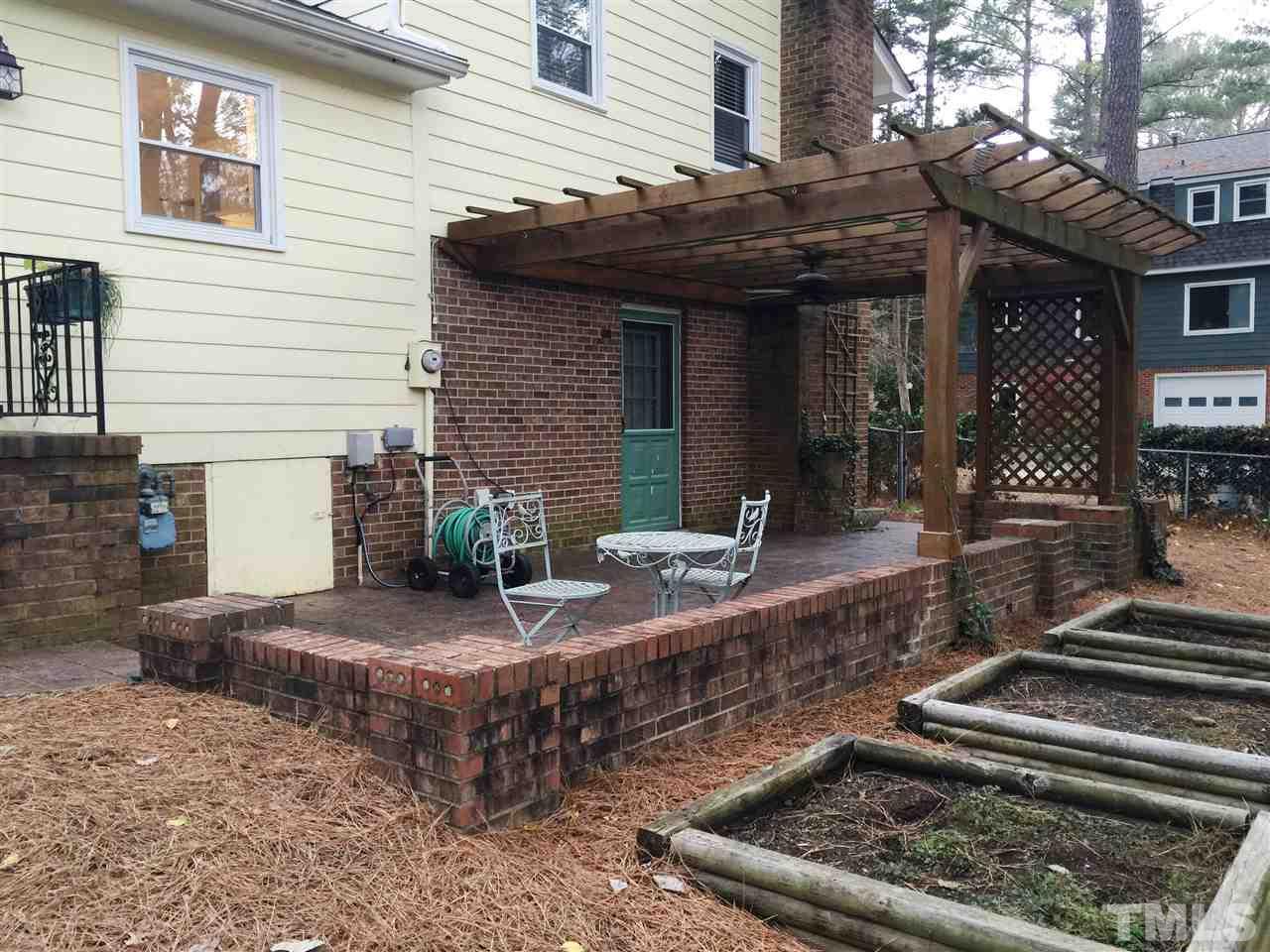 505 East Millbrook Road Raleigh, NC 27609 - Photo 16 of 25 a view of a house with barbeque and sitting area