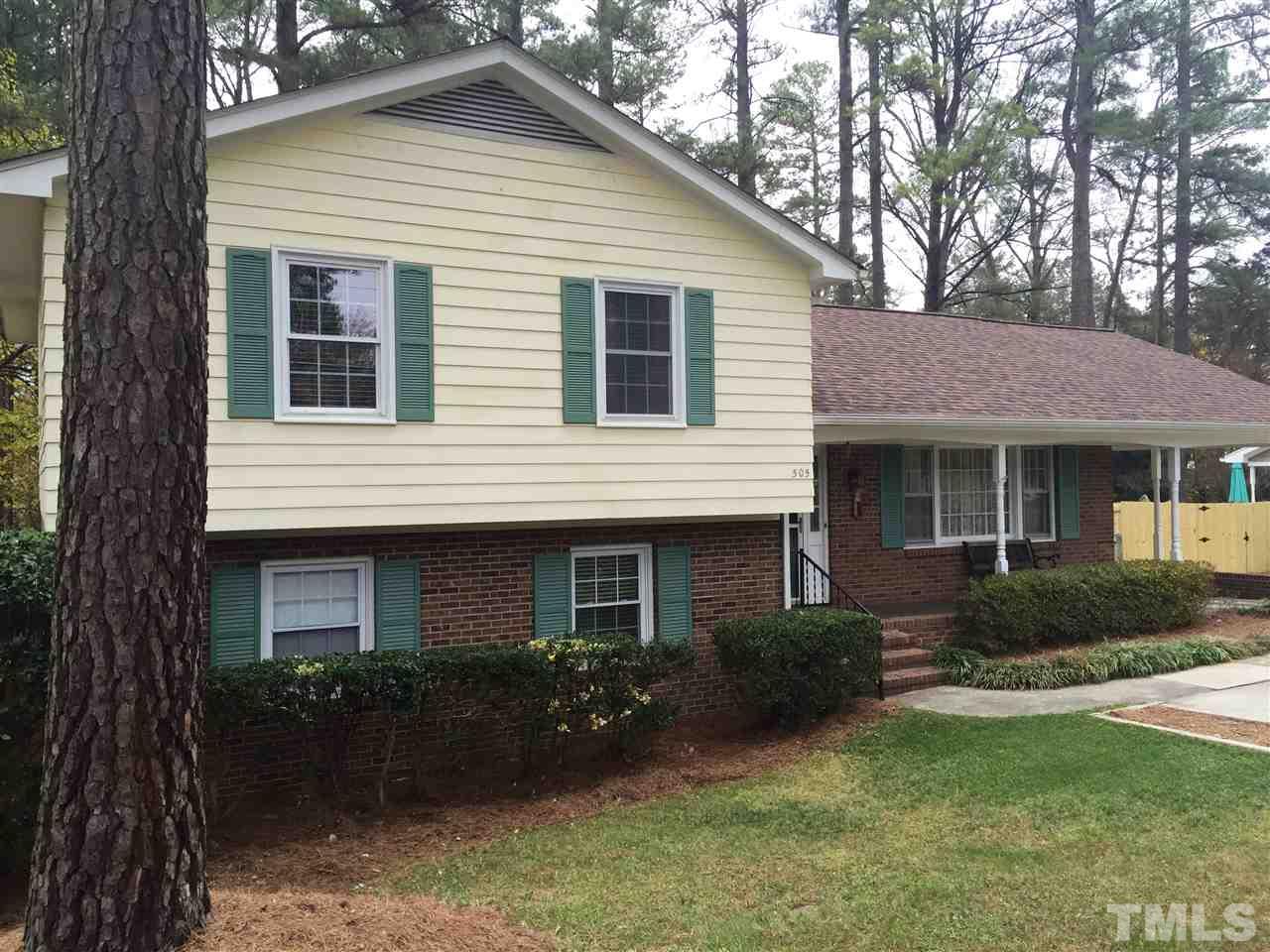 505 East Millbrook Road Raleigh, NC 27609 - Photo 20 of 25 a front view of a house with garden