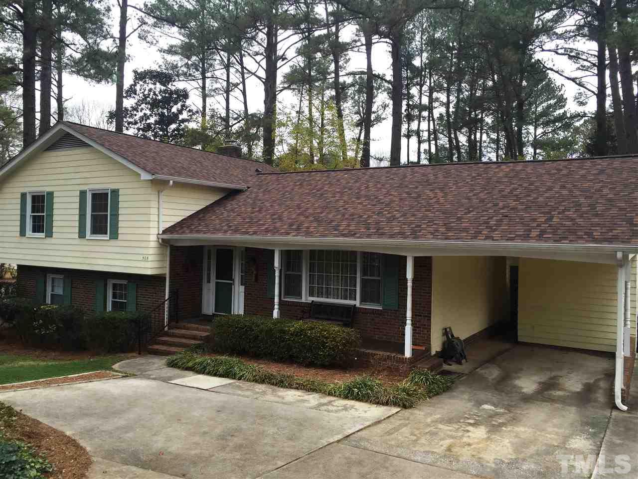 505 East Millbrook Road Raleigh, NC 27609 - Photo 21 of 25 a front view of a house with a yard and garage