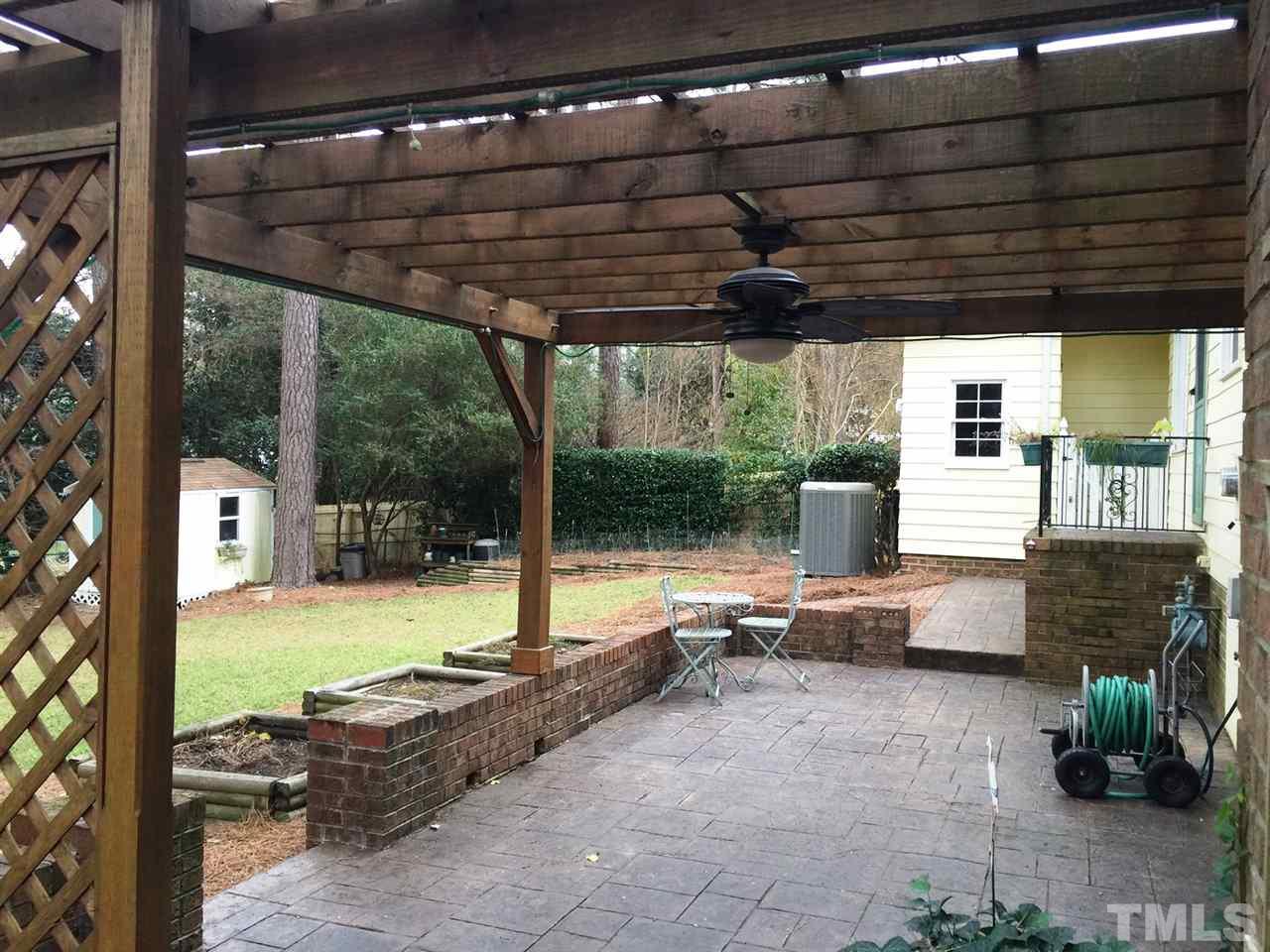 505 East Millbrook Road Raleigh, NC 27609 - Photo 22 of 25 a view of patio with a table under an umbrella
