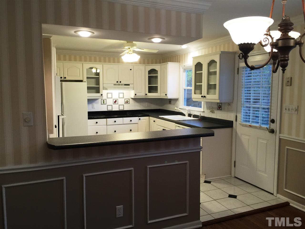 505 East Millbrook Road Raleigh, NC 27609 - Photo 4 of 25 a kitchen with a sink and a refrigerator
