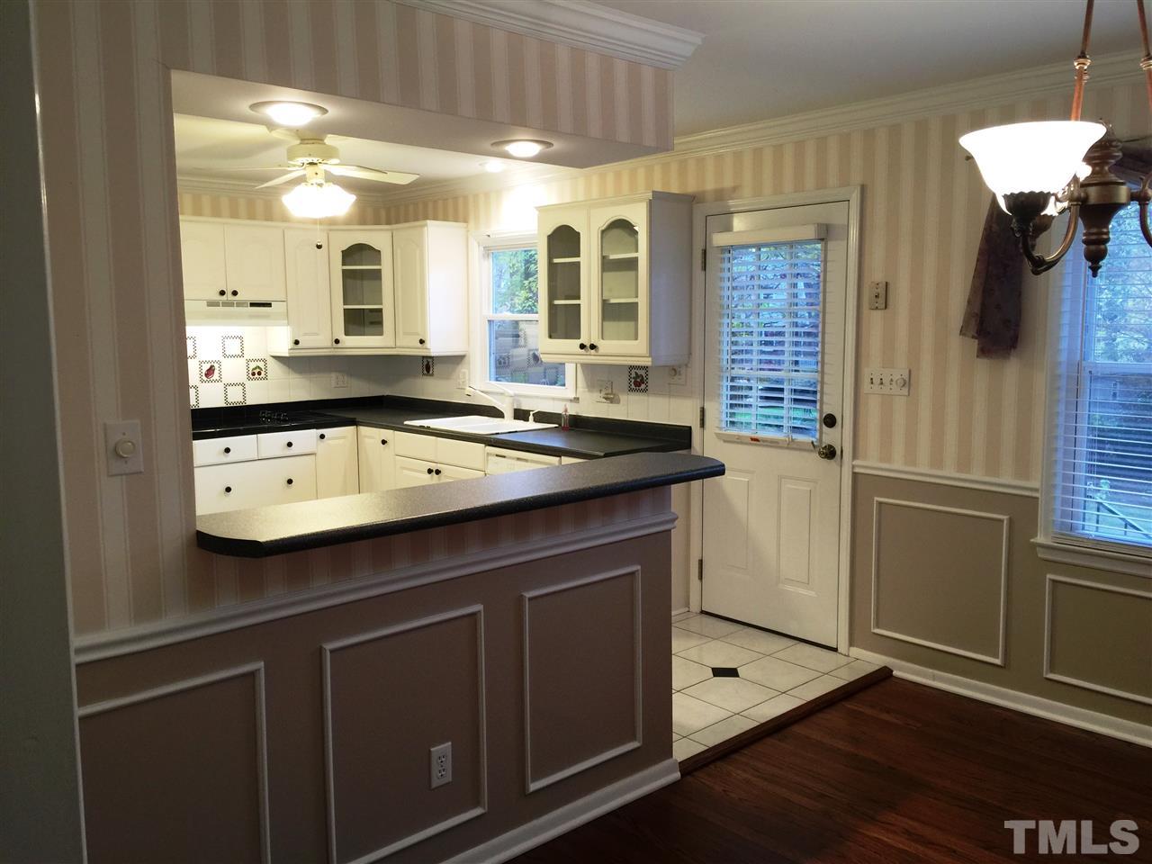 505 East Millbrook Road Raleigh, NC 27609 - Photo 6 of 25 a kitchen with a sink cabinets and wooden floor