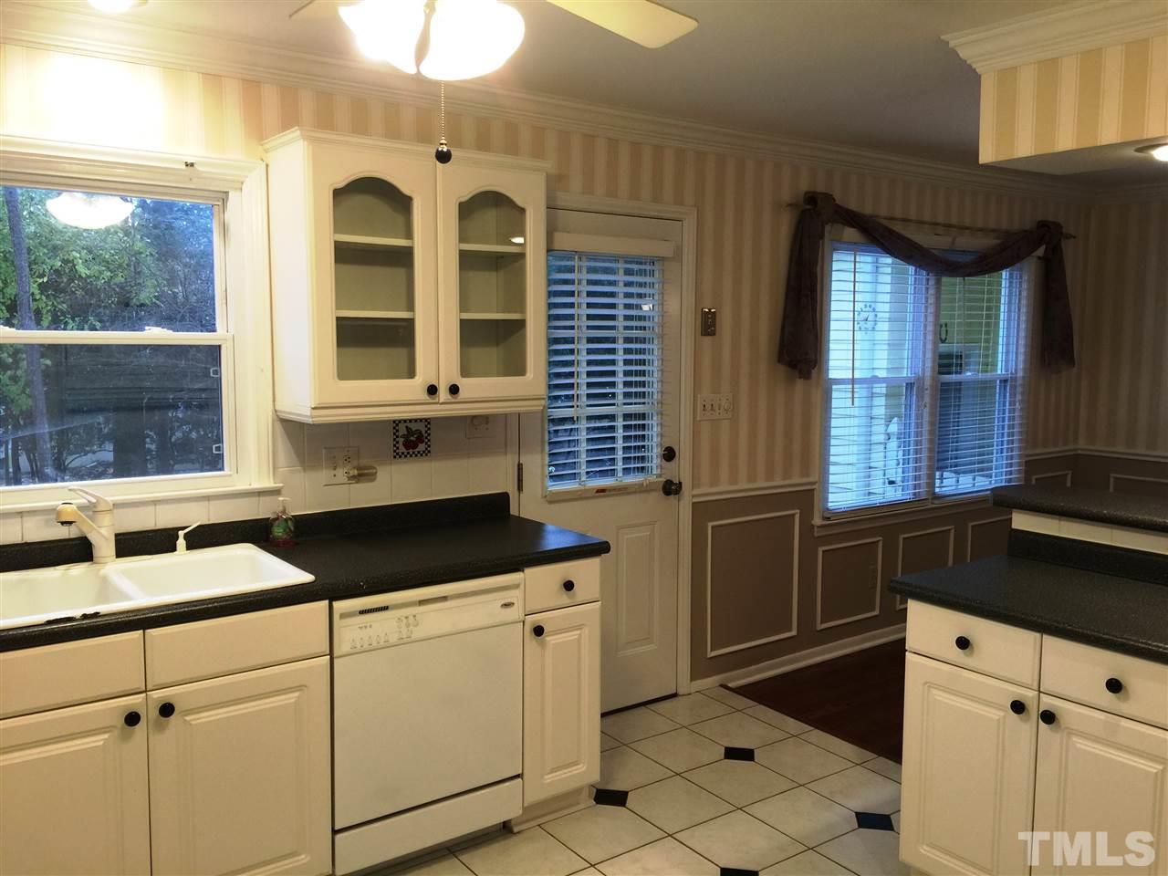 505 East Millbrook Road Raleigh, NC 27609 - Photo 7 of 25 a kitchen with granite countertop a sink and a stove