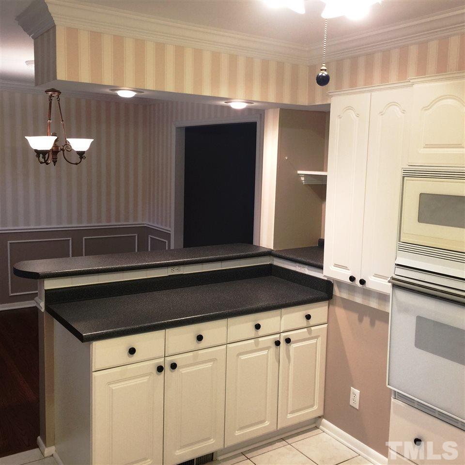 505 East Millbrook Road Raleigh, NC 27609 - Photo 9 of 25 a kitchen with a sink and cabinets