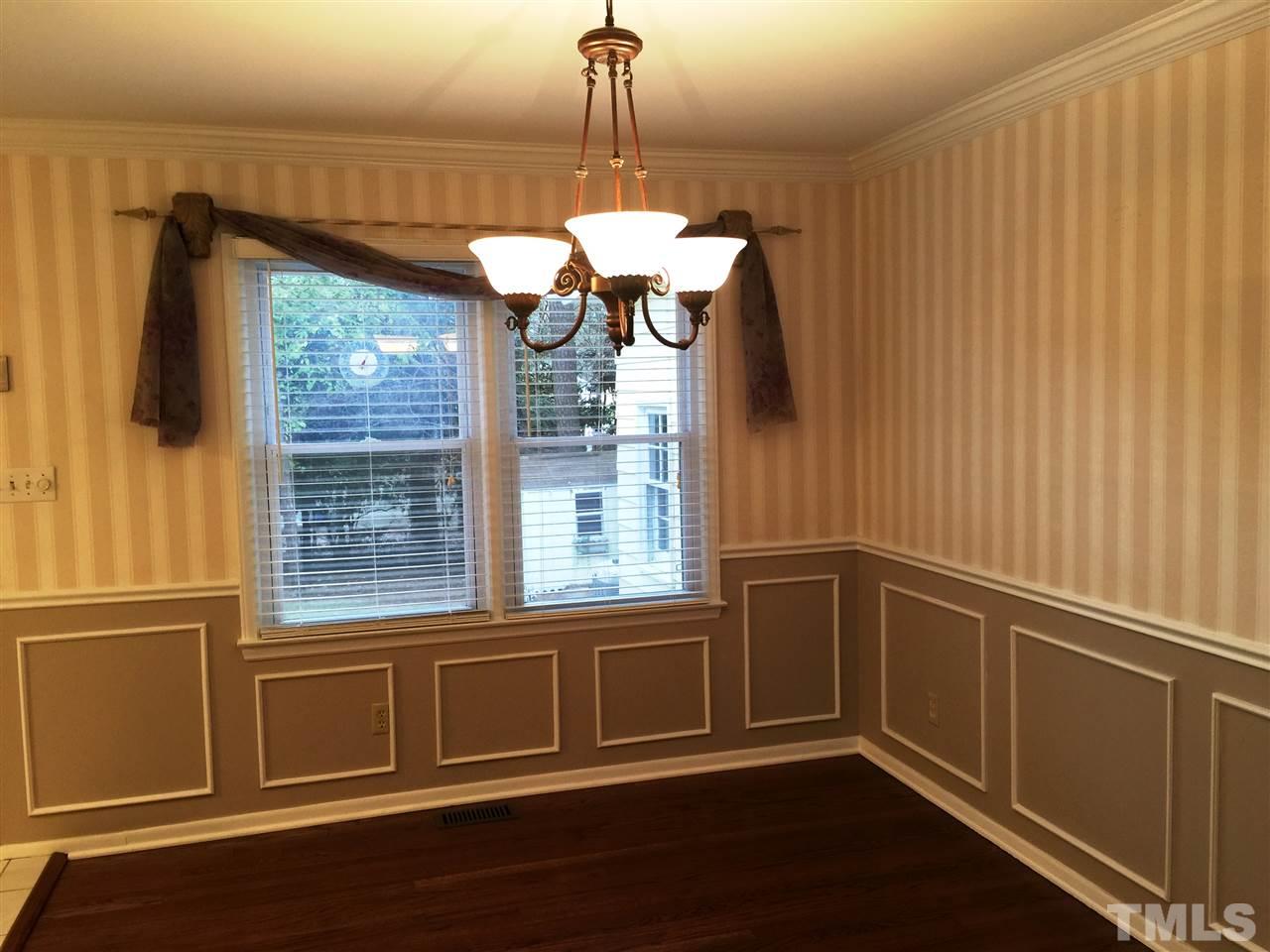 505 East Millbrook Road Raleigh, NC 27609 - Photo 10 of 25 a view of a kitchen with a large window and wooden floor
