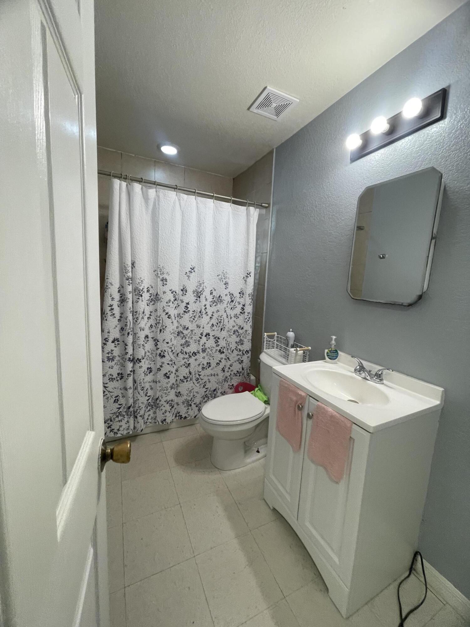 1220 A Road LaBelle, FL 33935 - Photo 22 of 42 a bathroom with a toilet sink and mirror