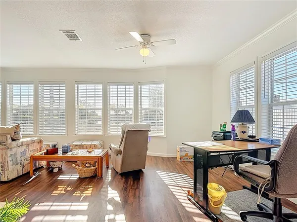 a living room with furniture and wooden floor