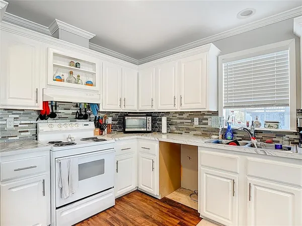 a kitchen with stainless steel appliances granite countertop a sink and a refrigerator