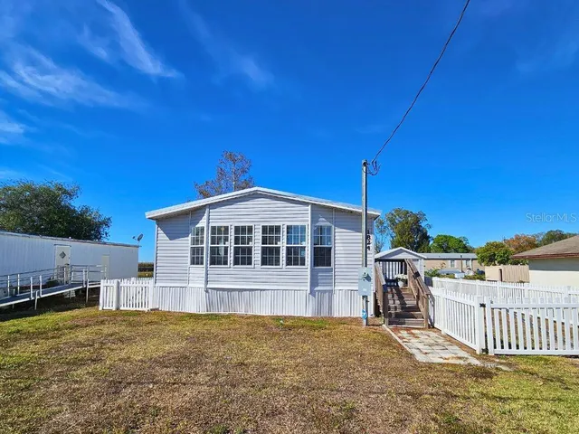 a view of a house with a backyard and a patio
