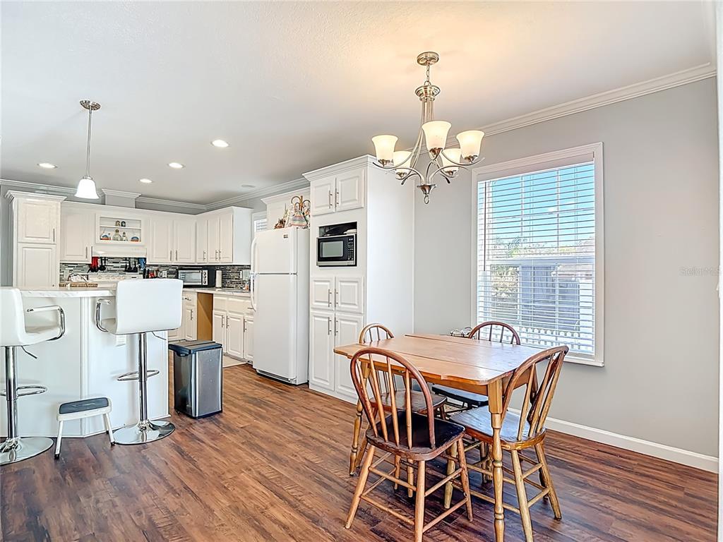 1824 Riverside Drive Moore Haven, FL 33471 - Photo 26 of 66 a view of a dining room with furniture and wooden floor
