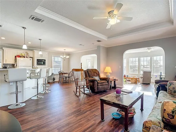 a bedroom with a bed a couch and a chandelier