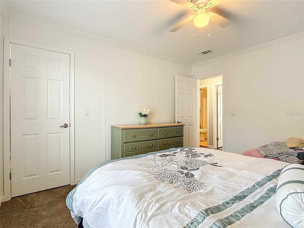1824 Riverside Drive Moore Haven, FL 33471 - Photo 35 of 66 a bedroom with a bed and a chandelier