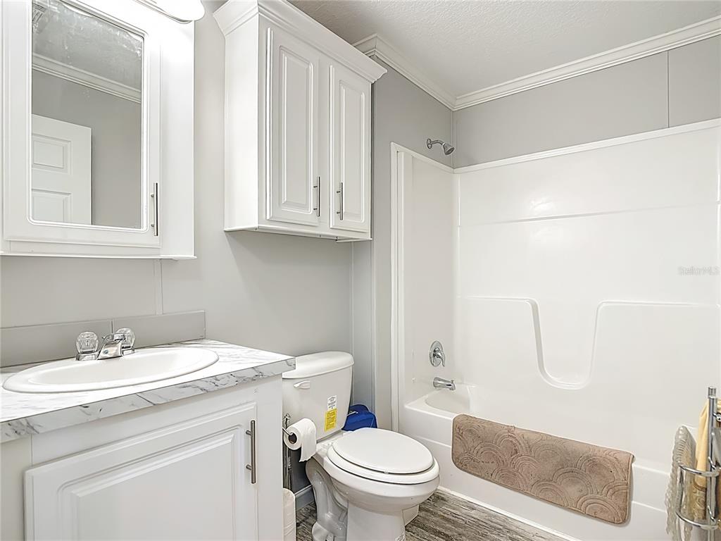 1824 Riverside Drive Moore Haven, FL 33471 - Photo 36 of 66 a bathroom with a sink a toilet and shower