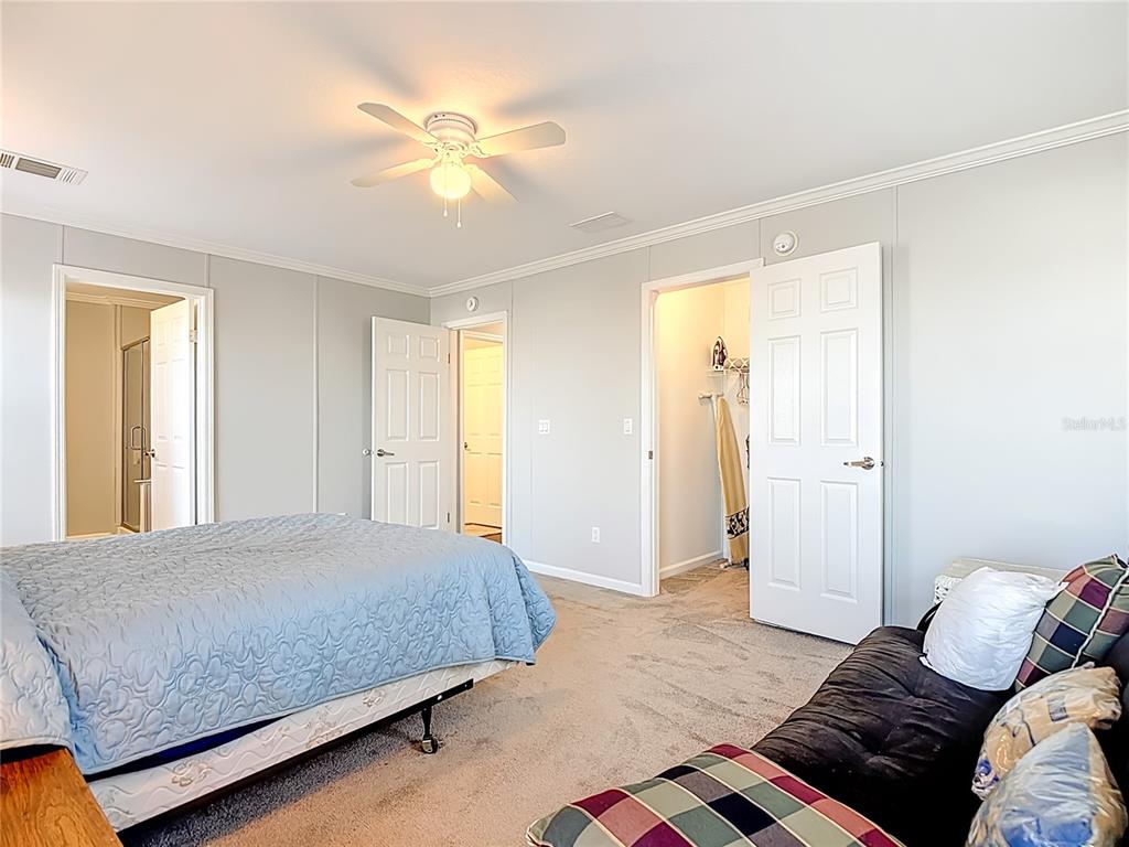 1824 Riverside Drive Moore Haven, FL 33471 - Photo 37 of 66 a bedroom with a bed and a chandelier
