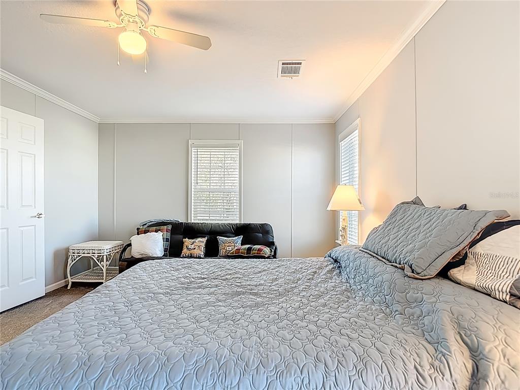 1824 Riverside Drive Moore Haven, FL 33471 - Photo 39 of 66 a bedroom with a large bed and a chandelier