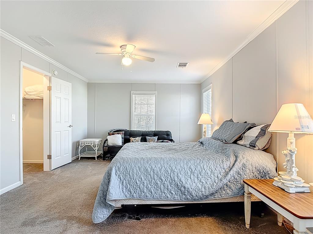 1824 Riverside Drive Moore Haven, FL 33471 - Photo 40 of 66 a bedroom with a bed and a chandelier