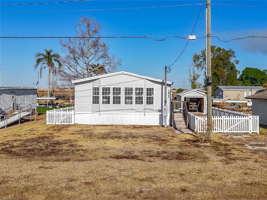1824 Riverside Drive Moore Haven, FL 33471 - Photo 4 of 66 a view of a house with a yard