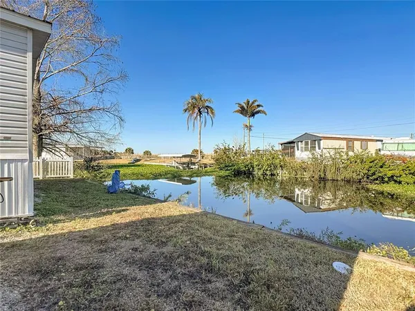 a view of a swimming pool with outdoor seating and a lake