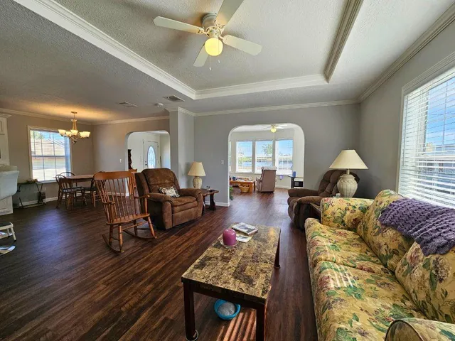a living room with furniture and wooden floor