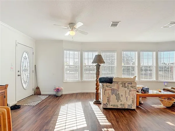 a living room with fireplace furniture and a large window