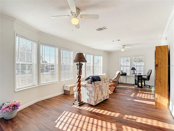 a living room with fireplace furniture and a wooden floor
