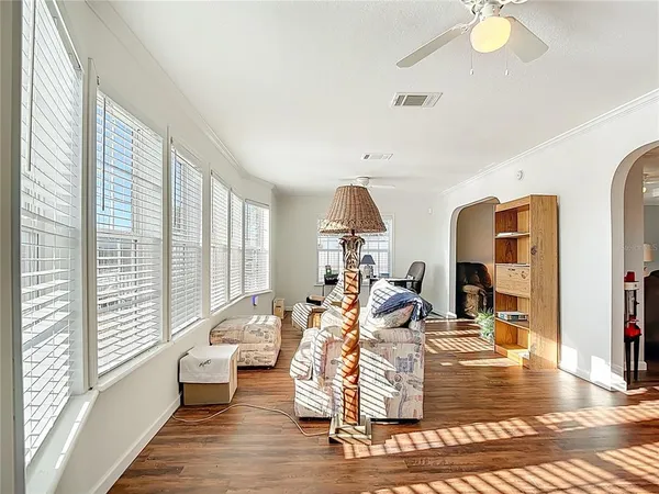 a living room with furniture window and wooden floor