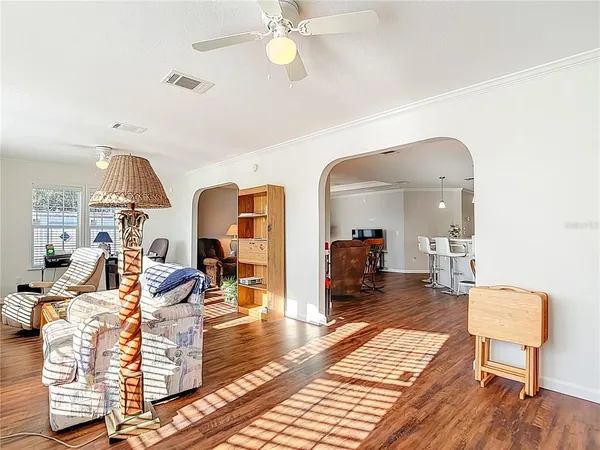 a living room with furniture fireplace and a large window