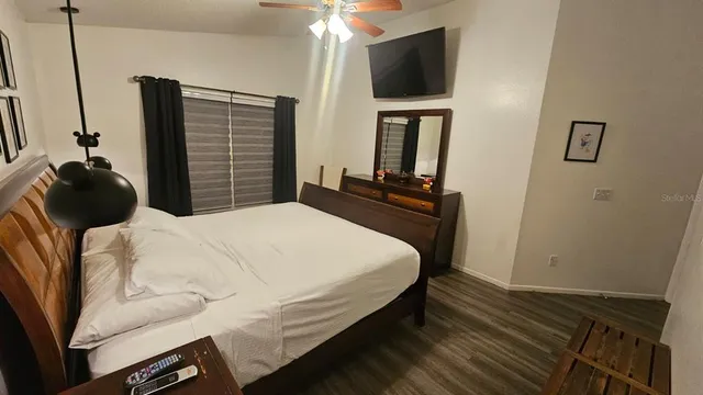 a bedroom with a bed and a television